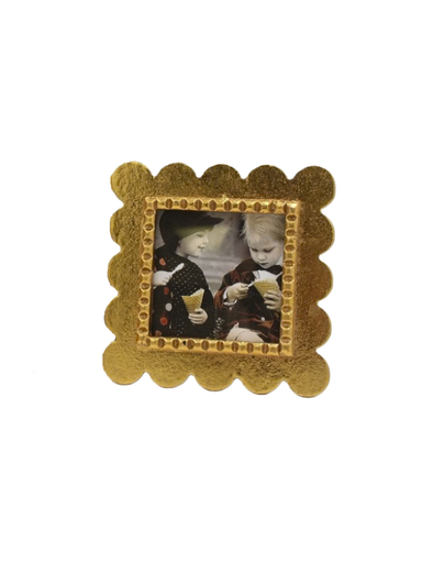 Gold decorative frame with scalloped edge.