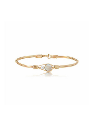 Gold bracelet with a central pearl on a white background