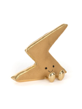 A gold-colored plush lightning bolt toy with a cute embroidered face, photographed on a seamless white background.