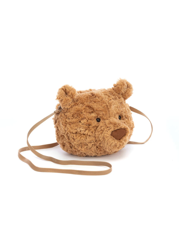 A plush teddy bear head crossbody bag in a warm tan-brown color, featuring a matching adjustable shoulder strap, photographed on a seamless white background.