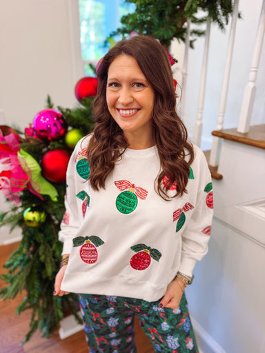 white sweatshirt with sequin  ornaments on the front 
