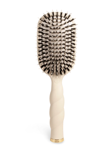 Beige hairbrush with black bristles