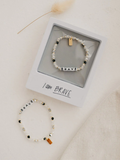 Bracelet with 'BRAVE' charm on a white background