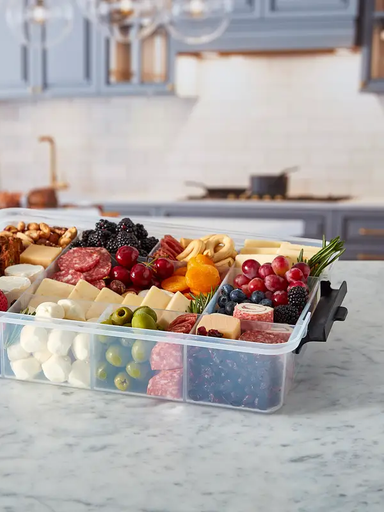 Clear container that holds assorted fruits, cheeses, and meats. Perfect for on the go!