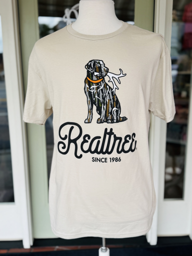 camo dog with a shed in mouth on tan tee