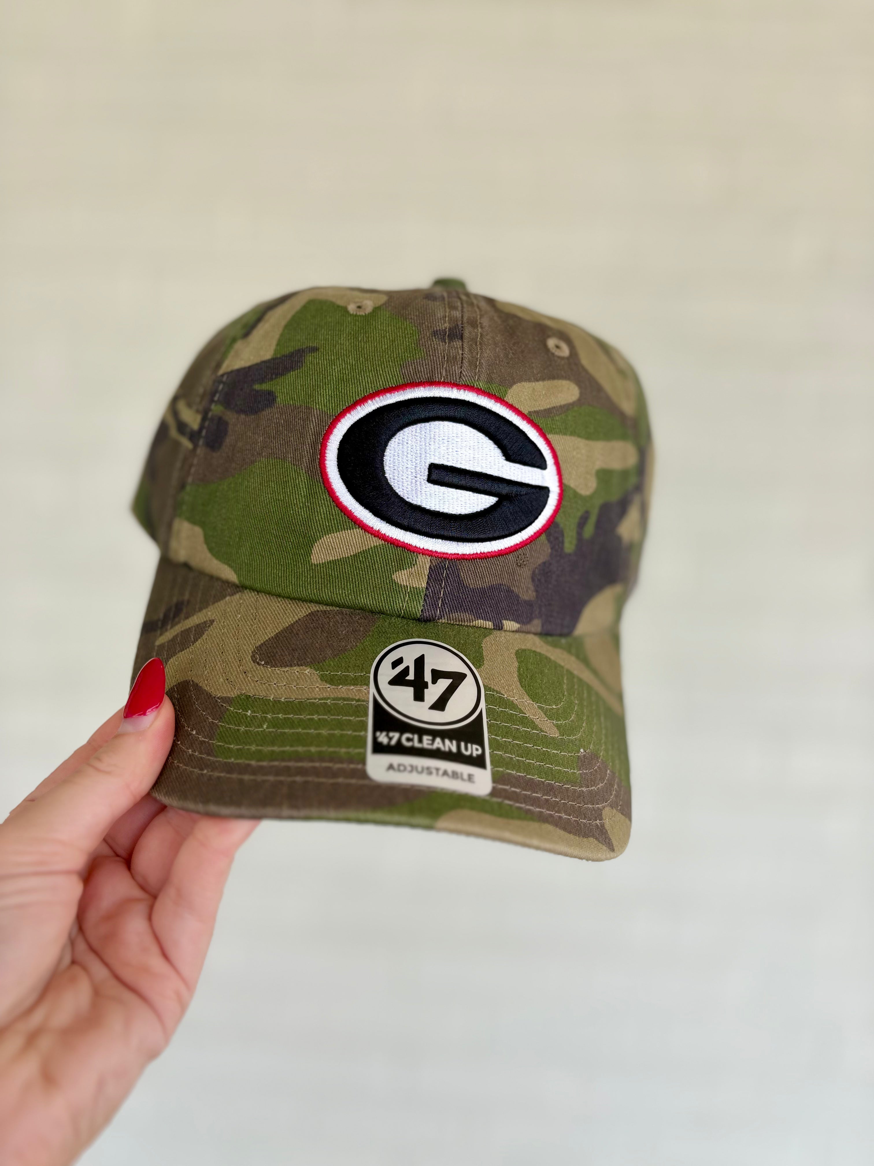 A camouflage baseball cap featuring a Georgia Bulldogs logo patch on the front and a '47 Clean Up sticker on the brim.