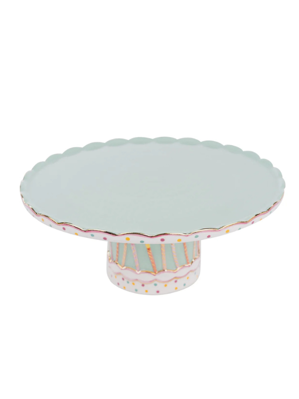 A cake stand with a patterned base and decorative candles around the circumference.