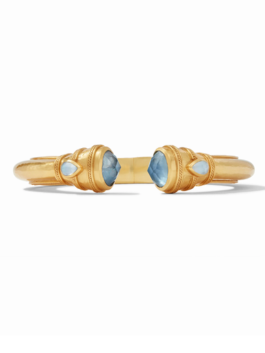 Pair of gold cufflinks with blue gemstones on a white background