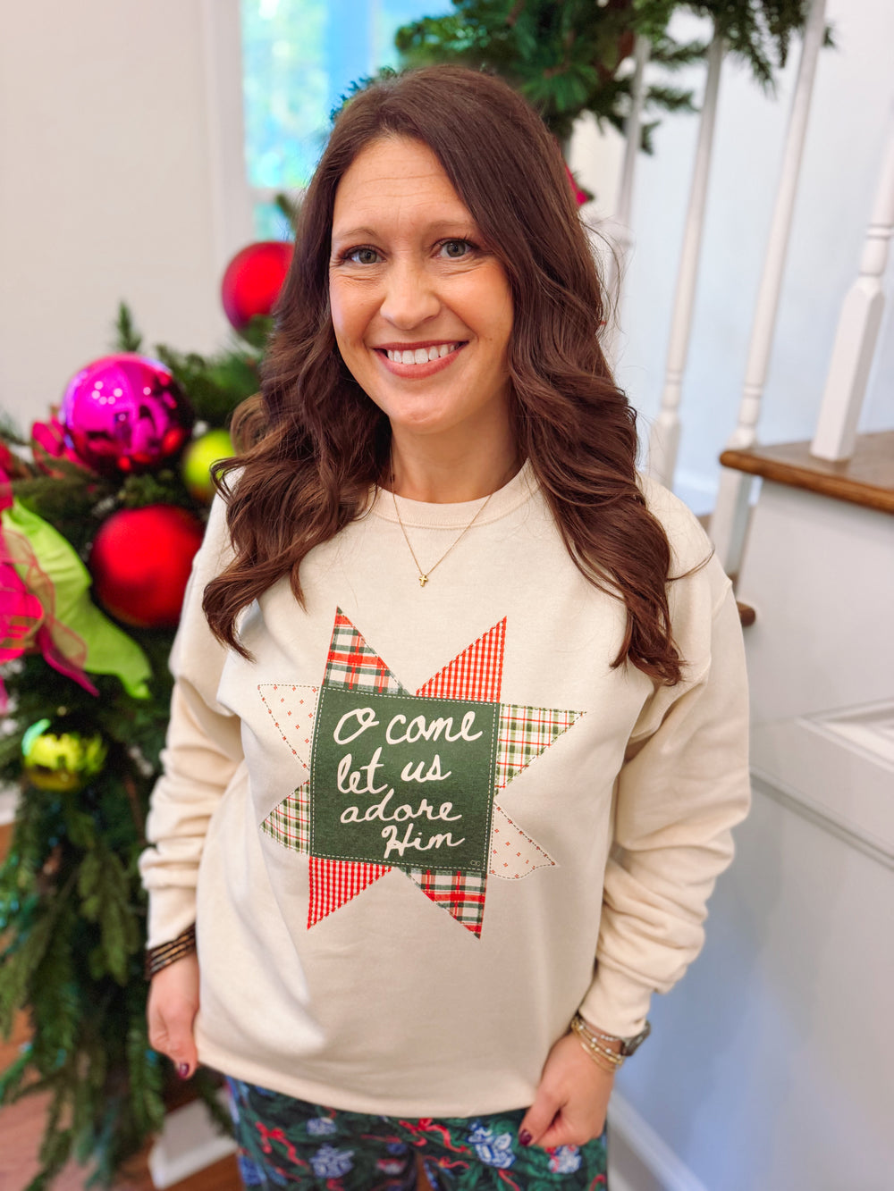 cream sweatshirt with a quilted design on the front in green and red 