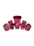 A glossy, chunky hair claw clip featuring a vibrant magenta pink and deep red abstract camouflage pattern.