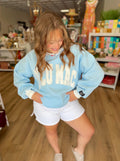 Light Blue Lulu Mac sweatshirt with white trim and Lulu Mac in white across the chest