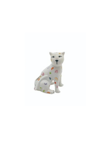 A white ceramic match holder in the shape of a sitting leopard with multicolored spots.