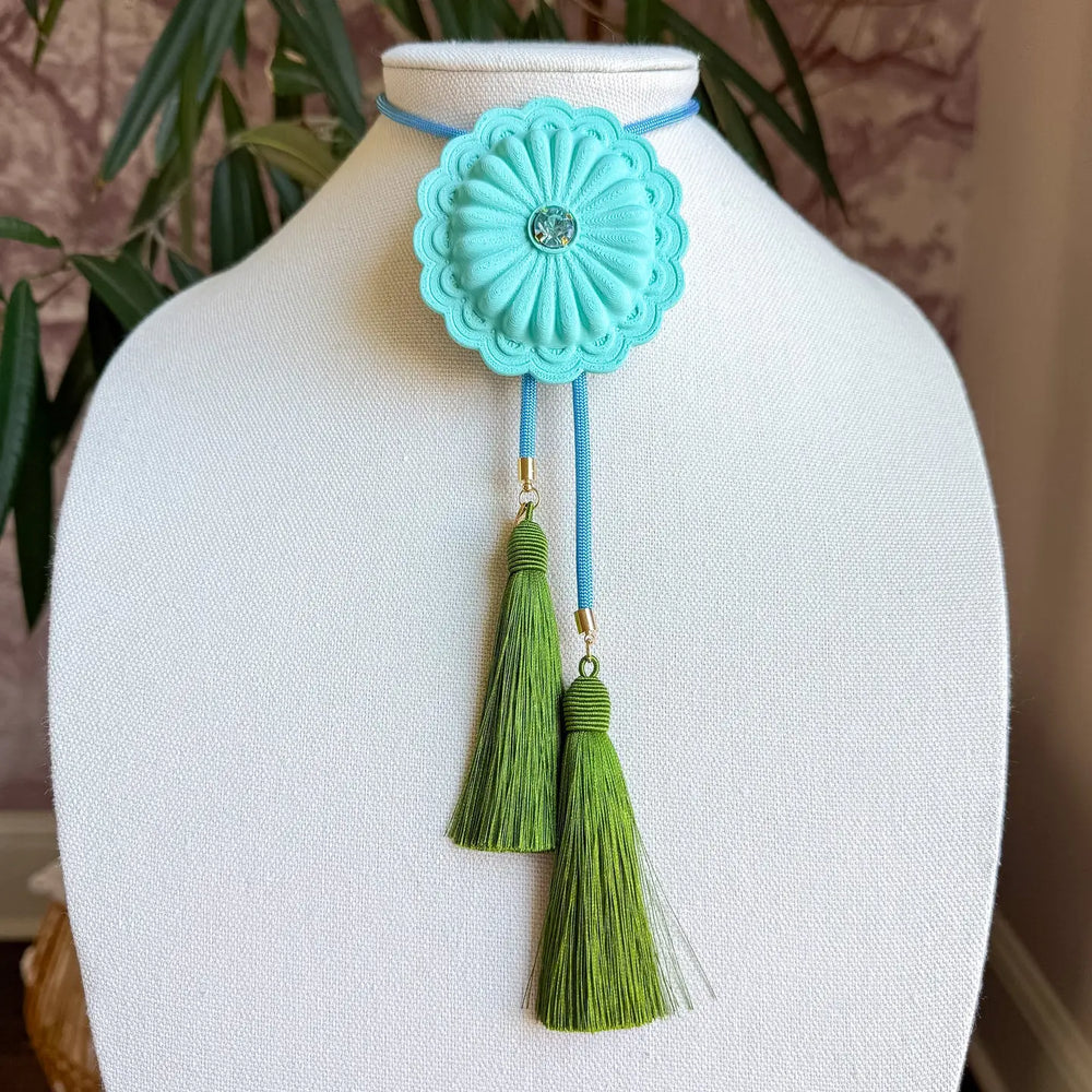This concho bolo brings Western tradition into modern dressing — a statement piece that feels both collected and styled on purpose.