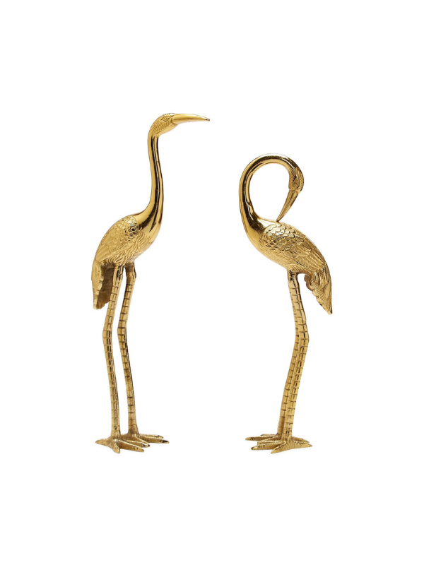 Two gold-toned decorative crane figurines with long legs and curved necks, shown side by side