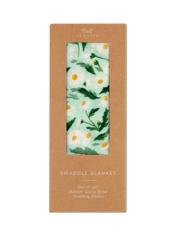 Swaddle blanket with floral daisy pattern in a cardboard box packaging