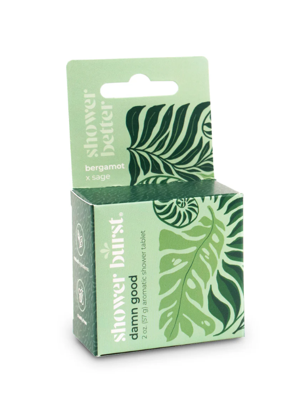 Green packaging of Shower Burst shower tablet with leaf design on a white background