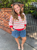 A red and white striped long-sleeve top thin black striped and red trim