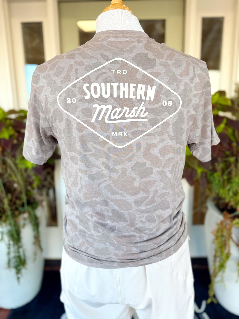 This short sleeve tee features an allover tonal camo print in soft neutral shades with a bold Southern Marsh logo graphic across the back.