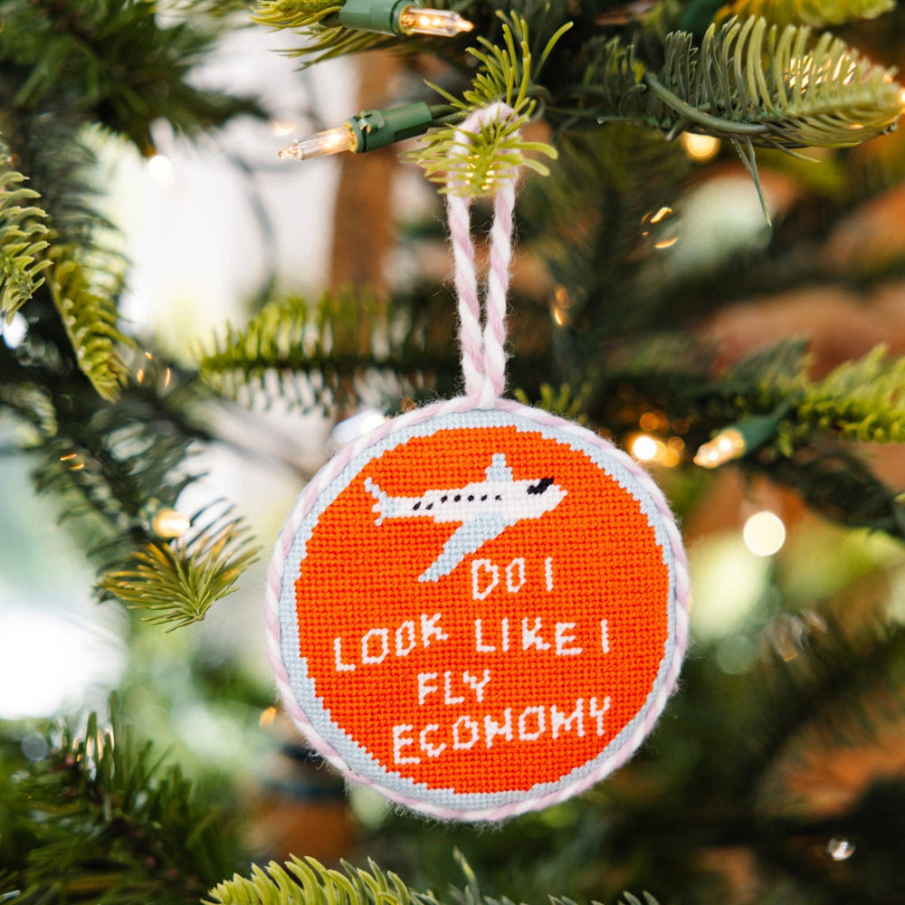 Decorative ornament with airplane and text on a Christmas tree