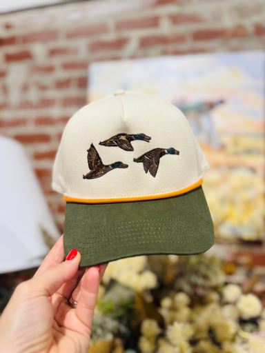 3 mallards in flight on a green and tan rope hat