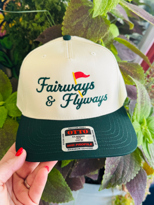 canvas hat with green fairway and flyways and an red flag on front 