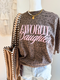 Leopard print graphic tee with pink “Favorite Daughter” lettering styled with denim shorts and layered necklaces
