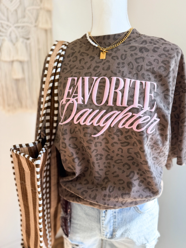 Leopard print graphic tee with pink “Favorite Daughter” lettering styled with denim shorts and layered necklaces