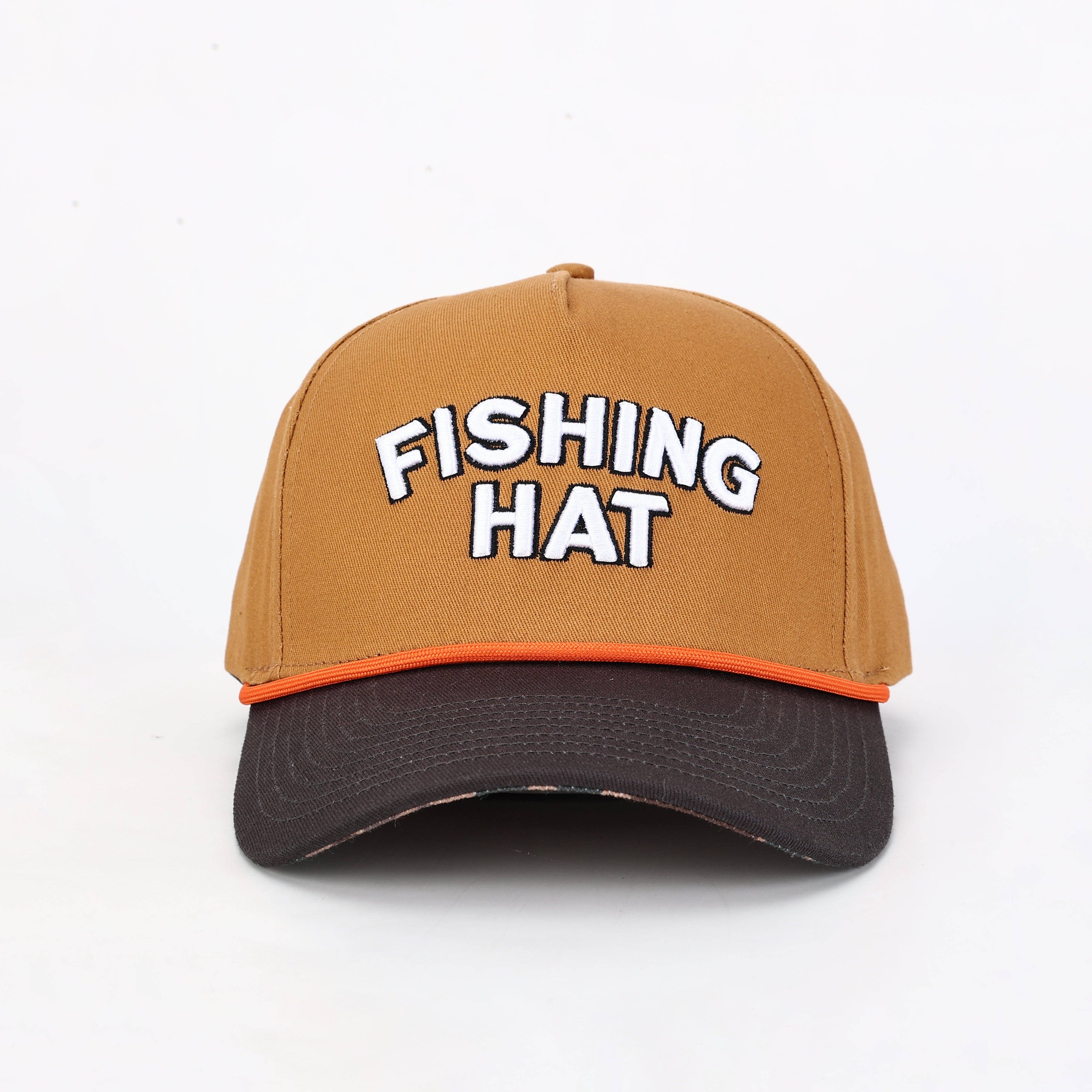 A structured baseball cap with a tan crown, a dark brown curved brim, and an orange accent line. The front of the cap features the words 'FISHING HAT' embroidered in white 