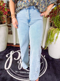 Light wash jeans with embroidered detailing down the sides of the legs