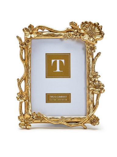 A gold floral spray frame designed to hold a 5x7 photo, featuring a decorative border with floral motifs.
