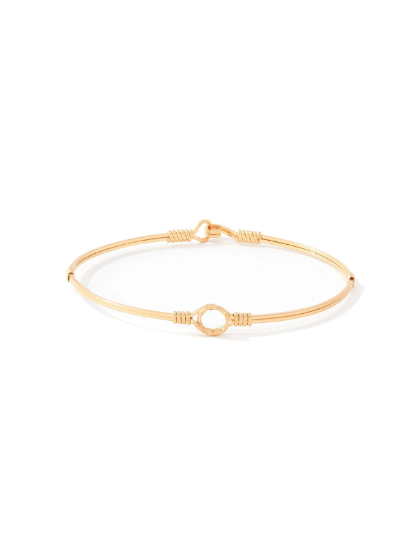 A delicate gold bangle bracelet with a central open circle and textured wrap details, displayed on a clean white background.