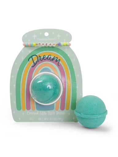 A greenish blue bath bomb with a friendship bracelet that says "dream"