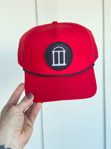 red hat with black arches in a circle on the front 