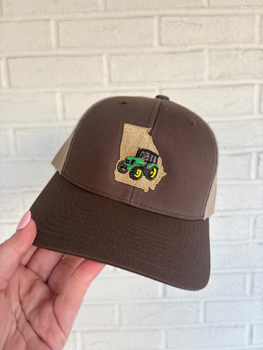 Brown trucker hat with georgia state outline and green john deere tractor embroidered detail 