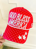 Red cap with white polka dots and 'God Bless America' text on a beige background