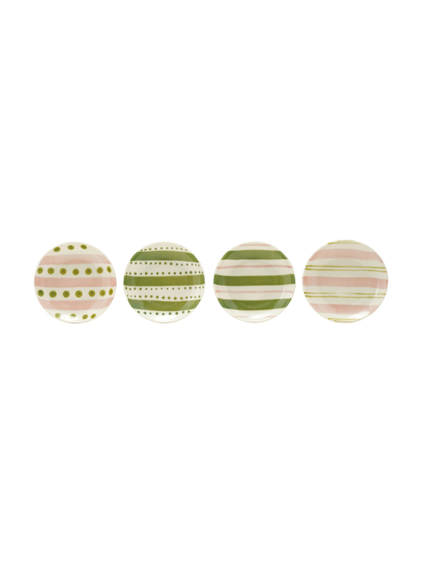 Four round decorative plates lined up horizontally, each featuring a different pastel pattern including stripes, dots, and polka dots in pink, green, and cream.