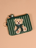 This hand-beaded coin purse features a sweet teddy bear design on a rich green striped background, complete with a coordinating bow and beaded zipper pull.