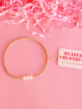 Gold beaded bracelet with 3 pearl beads on it