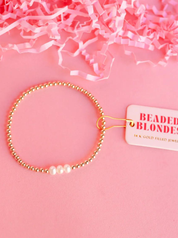 Gold beaded bracelet with 3 pearl beads on it