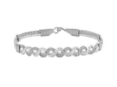 Silver bracelet with intricate design on a white background