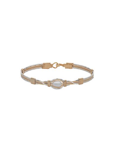 Gold bracelet with a central pearl on a white background