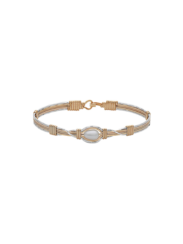Gold bracelet with a central pearl on a white background