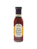 A bottle of Honey Sriracha Barbecue Sauce by Stonewall Kitchen with a label showing the product name and the phrase 'True Grill Masters Know'. The sauce appears dark red and is packaged in a clear glass bottle.