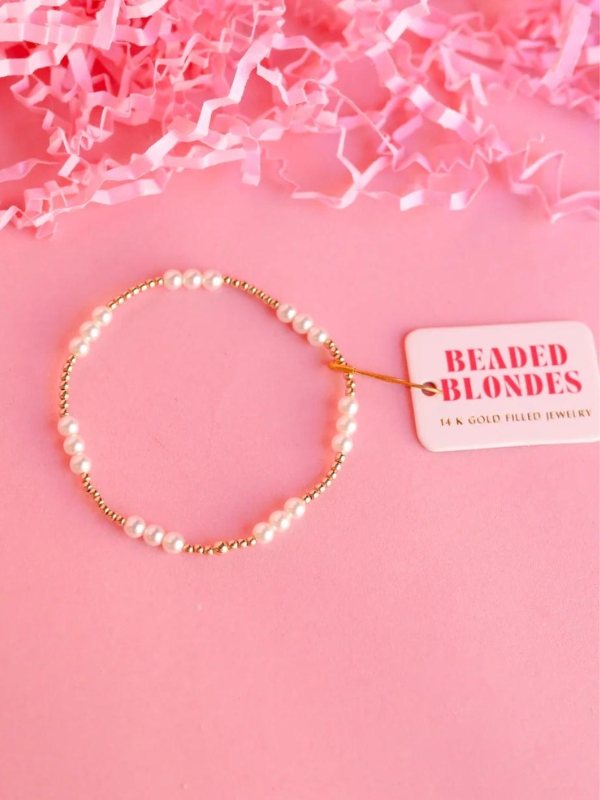 A gold-filled beaded bracelet with white pearls and gold accents