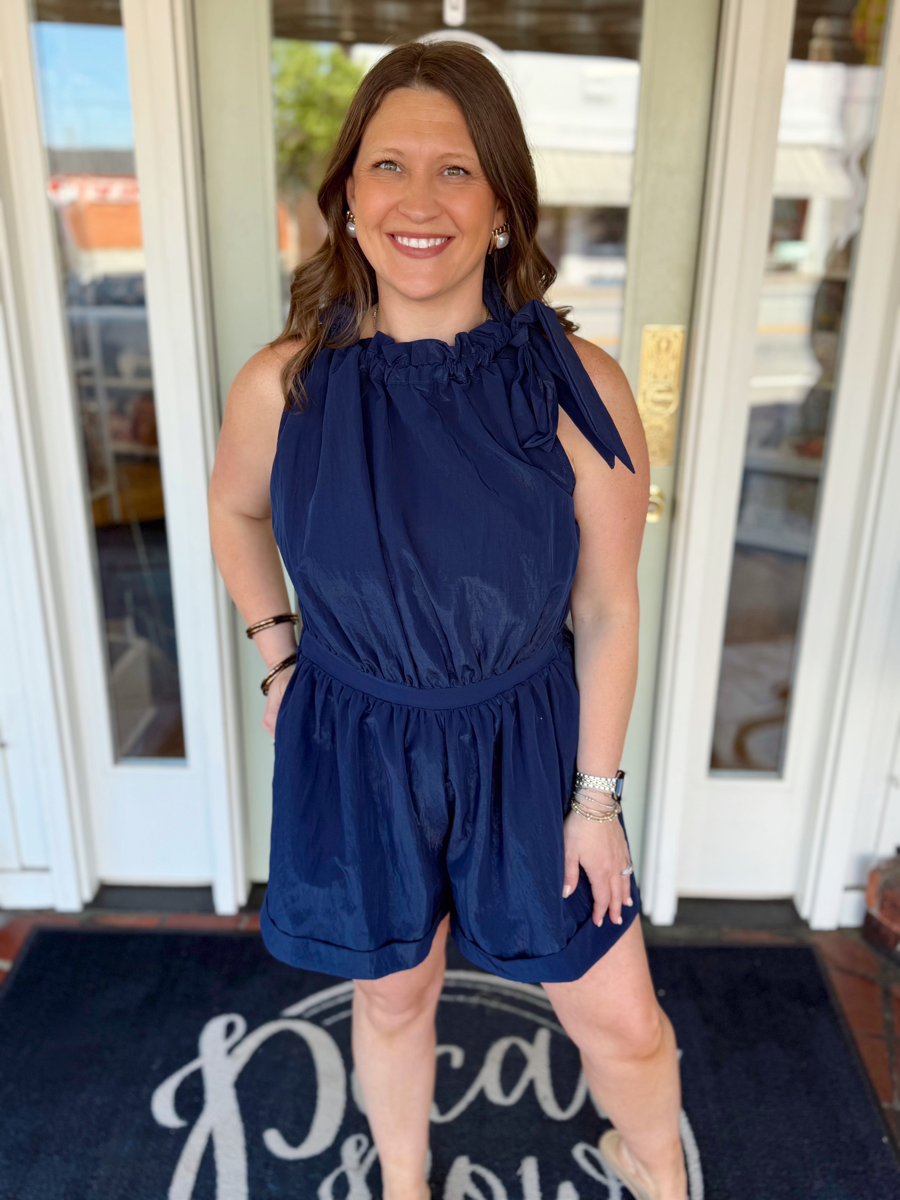 The Maya Ruffle Neck Tie Romper in Navy