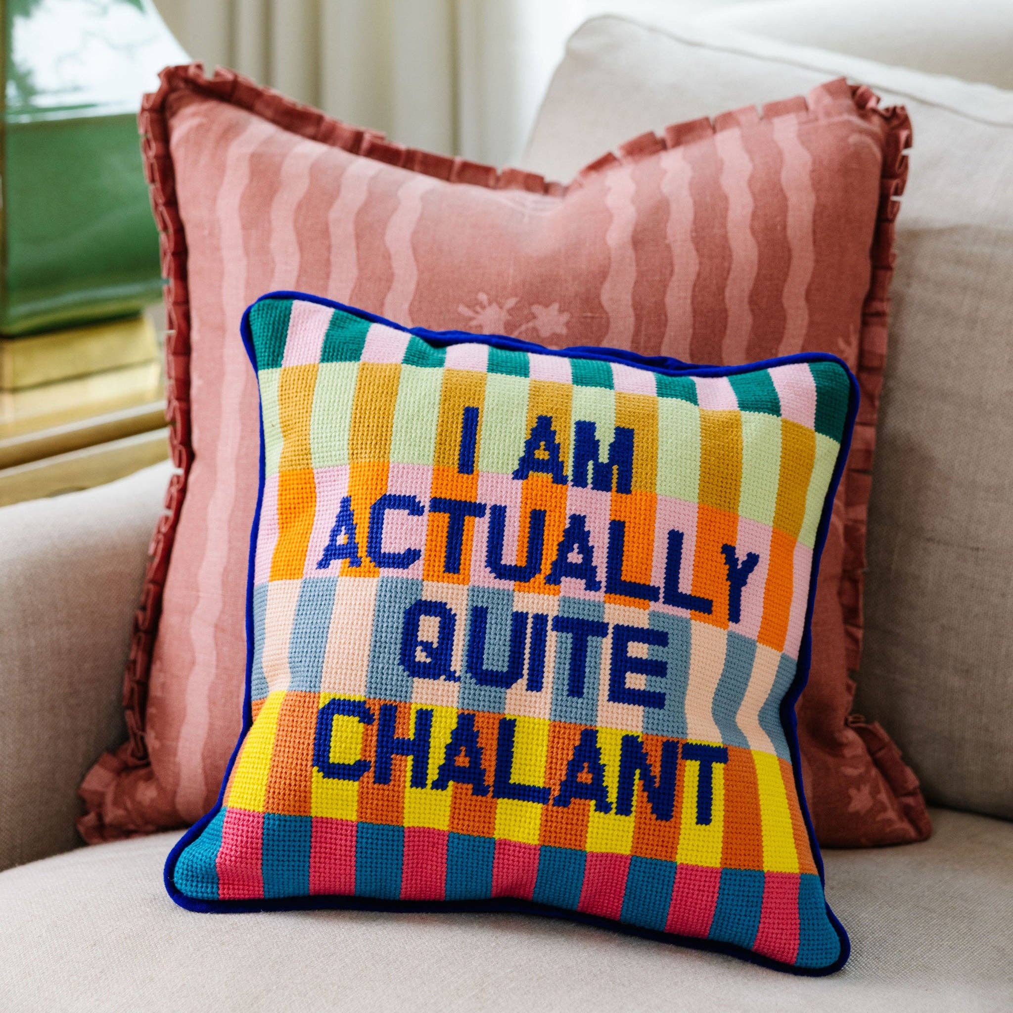 Colorful pillow with text on a couch