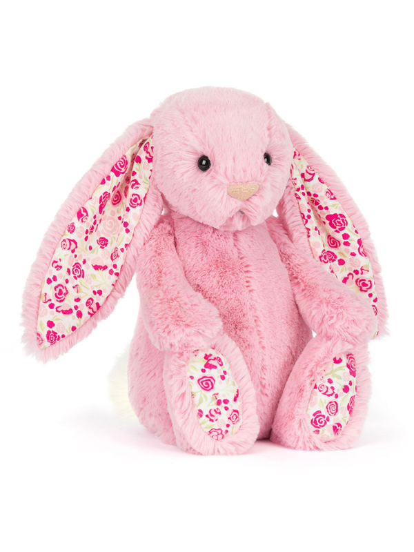 Pink plush bunny with floral patterns on a white background