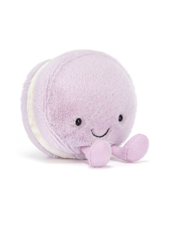 Purple plush toy with a smiling face on a white background