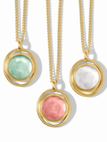 Three gold necklaces with colorful stone pendants on a white background