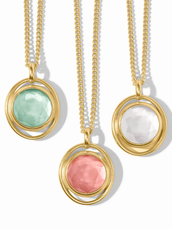 Three gold necklaces with colorful stone pendants on a white background